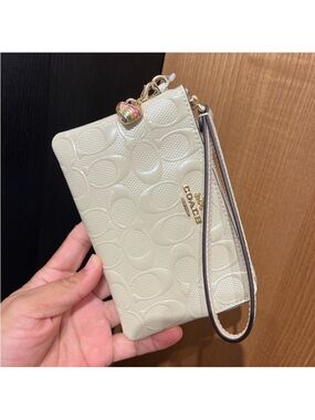 Coach Corner Zip Wristlet In Signature
Leather With Heart Charm